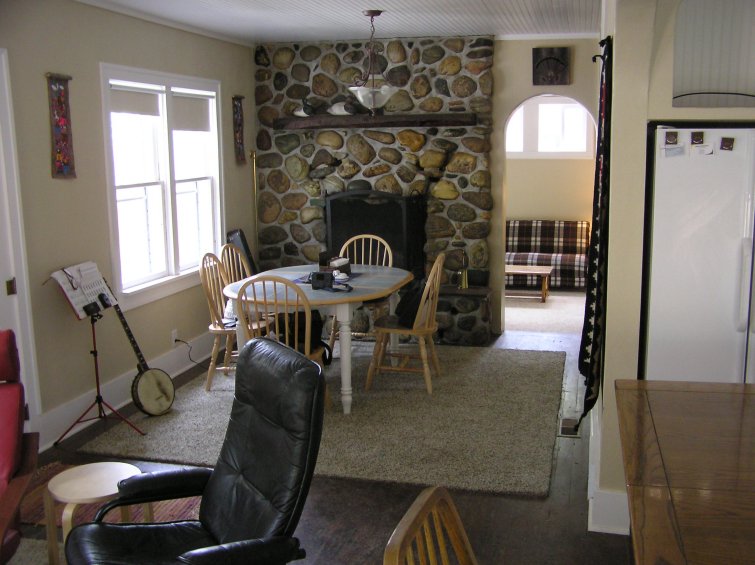 Dining area of Ennis rental house with fireplace in background